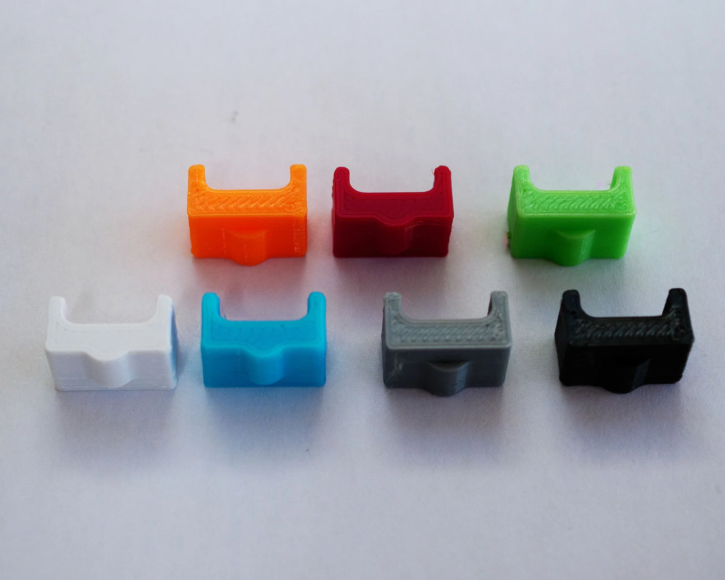 Set of eight colorful plastic clips on a white background. robot retro 3D spacer