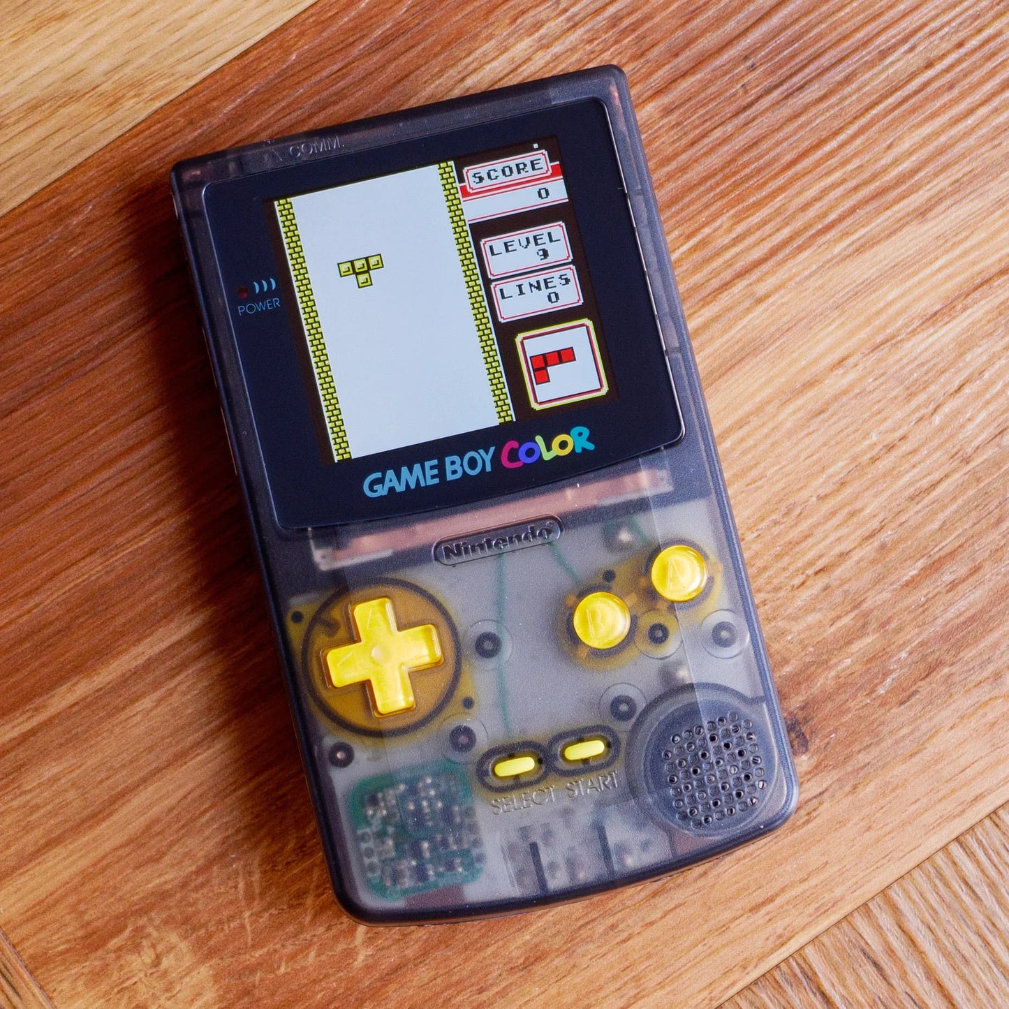 Game Boy Color on a wooden surface robot retro