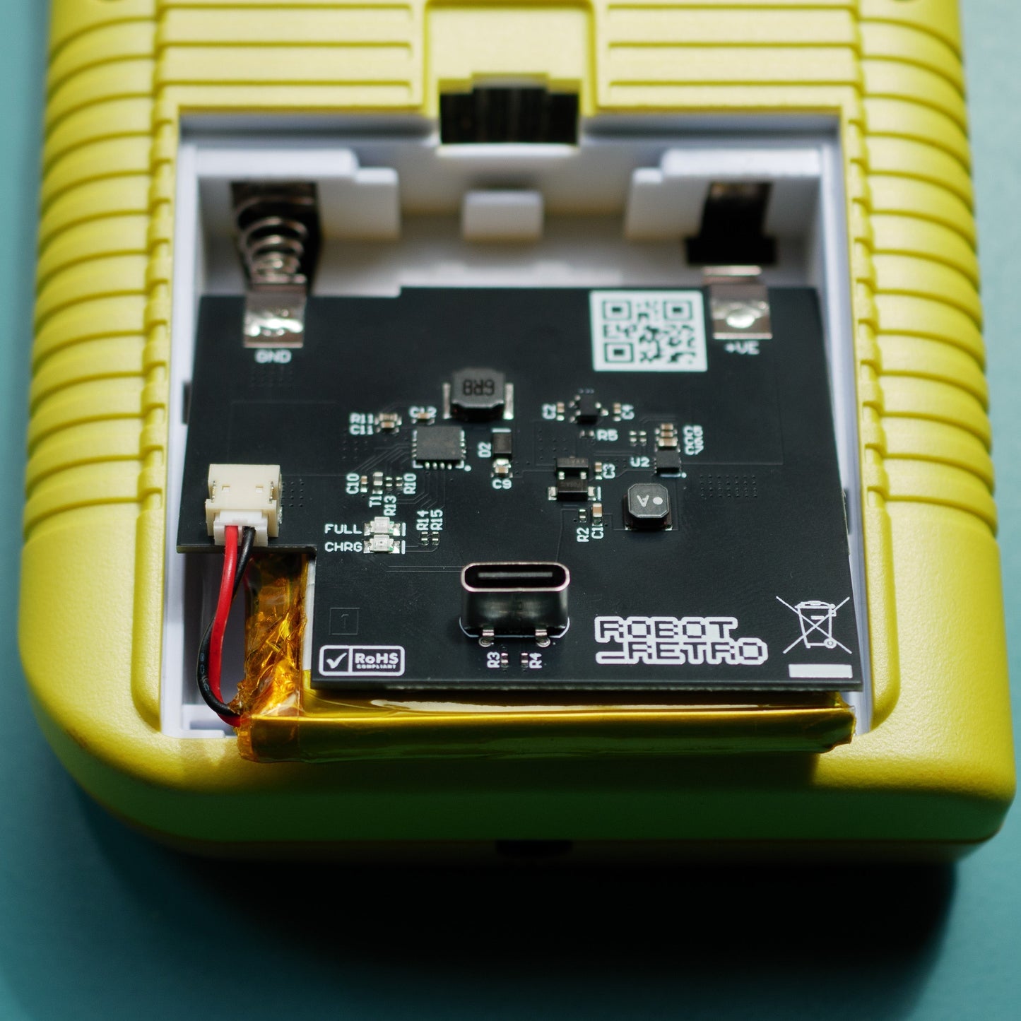 USB-C rechargeable 3000 mAh battery installed inside a classic Game Boy Original (DMG) console showing charging cable connected robot retro