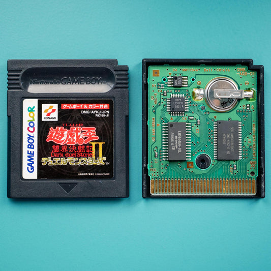 Nintendo Game Boy Color cartridge and its internal circuit board on a teal background