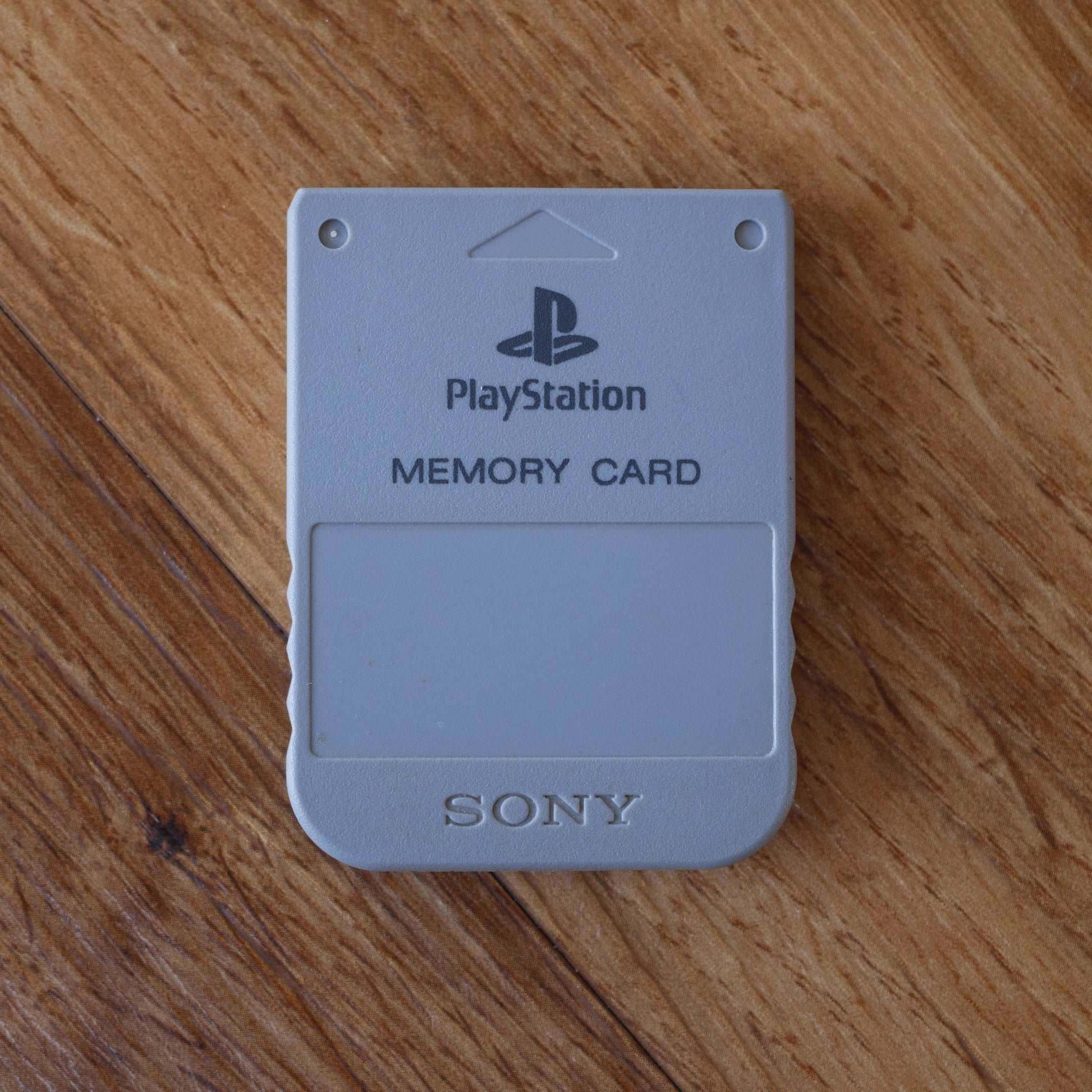 PlayStation memory card on a wooden surface